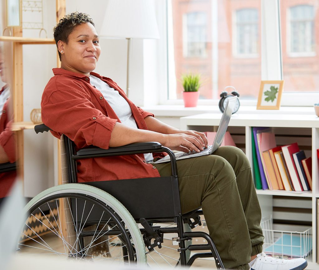 Woman in wheelchair with laptop computer